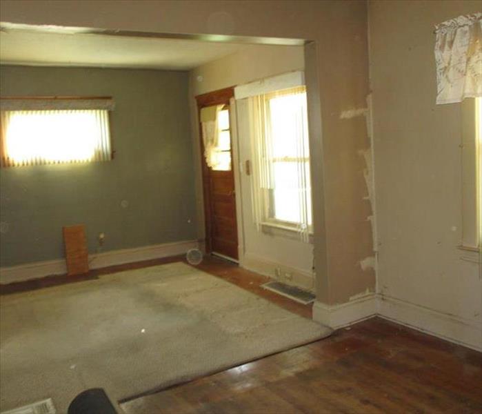 A living room in Canton with soot damage to the walls, ceiling and floors