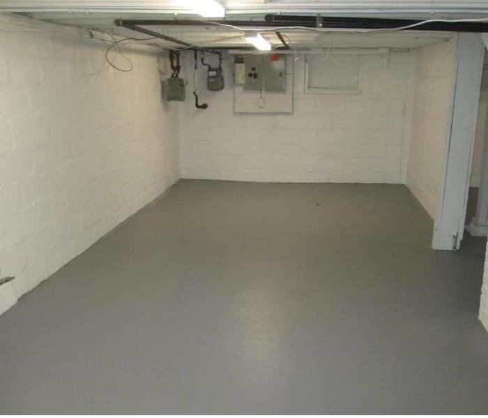 This Canton basement is restored from a dryer fire. Crisp white walls and a freshly painted grey floors. 
