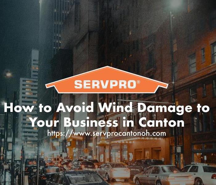 Orange SERVPRO  house logo on image with winter windy day with business downtown. 