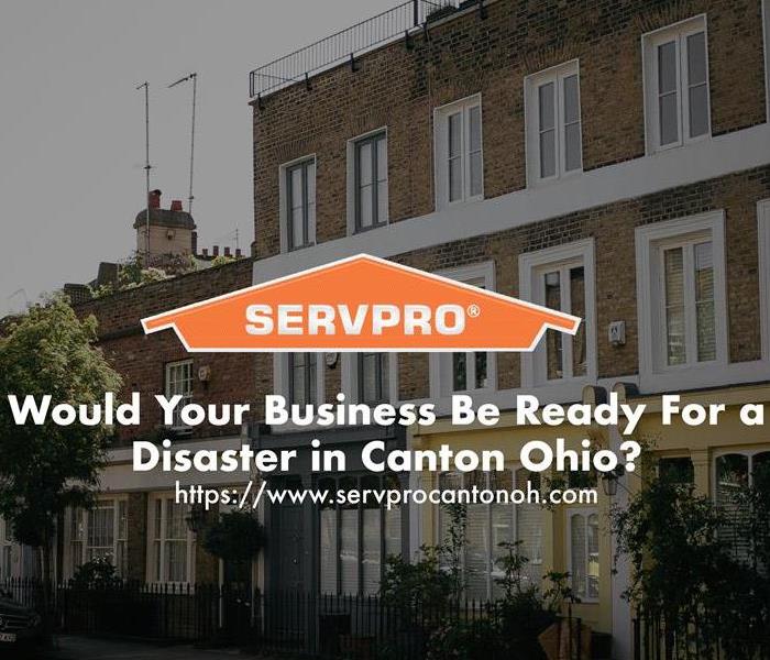 Orange SERVPRO house logo on image with commercial buildings